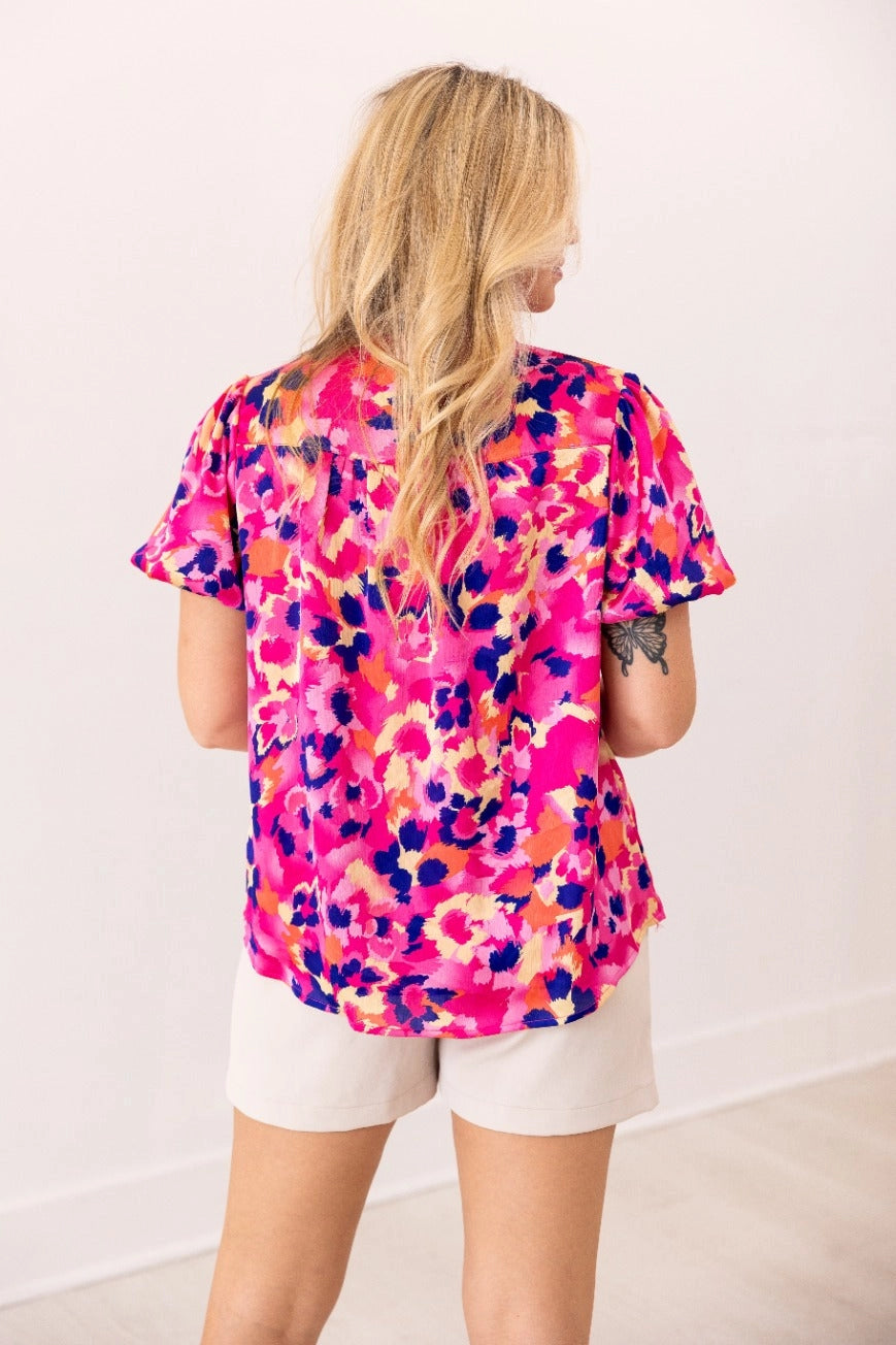  Floral Blouse is a vibrant and stylish addition to your wardrobe. Designed with a button-front closure and chic puff sleeves.