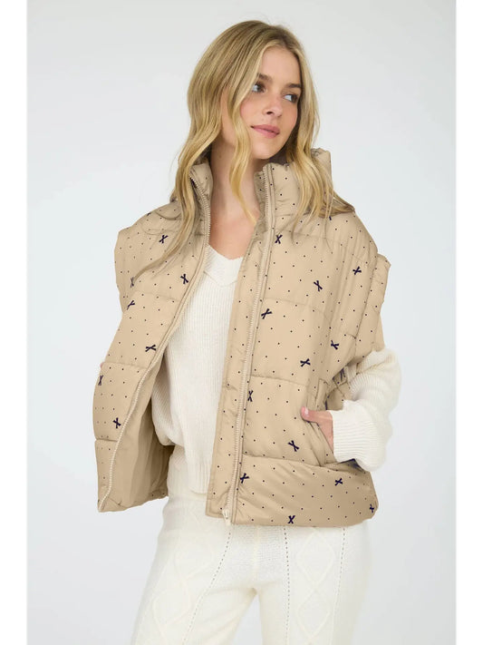 Light Khaki Polka Dot Bow Puffer Vest is a stylish and functional layering piece perfect for cooler weather. 