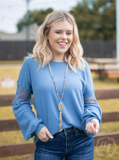 Denim Blue Lace Accent Top is a perfect blend of comfort and style. Featuring delicate lace details on the sleeves and a relaxed fit.