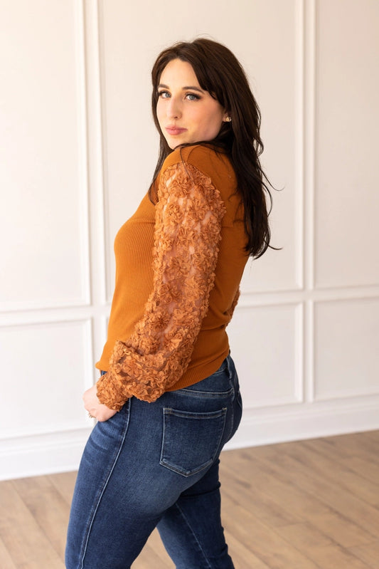 Rust Lace Sleeve Top combines timeless elegance with modern charm. Featuring intricate lace sleeves and a classic crew neckline.