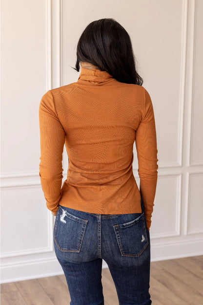 Rust Turtleneck with a fitted design.