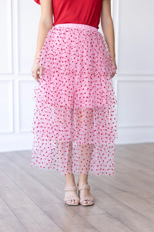 Heart Tiered Tulle Skirt is a whimsical and romantic piece perfect for adding a playful touch to your wardrobe. Featuring multiple layers of soft tulle adorned with delicate heart patterns.