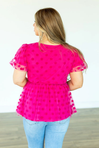  Polka Dot Peplum Blouse is a chic and versatile piece designed for effortless transitions from day to date night. Featuring a crew neck, flattering peplum silhouette, and an elastic waistband.