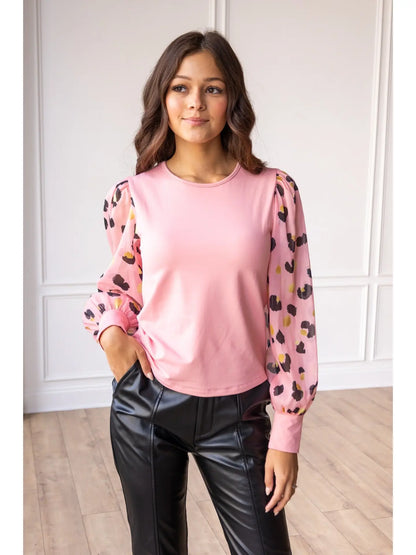 Pink Leopard Sleeve Top is a stylish blend of simplicity and boldness. Featuring sheer leopard-print puff sleeves and a sleek solid bodice.