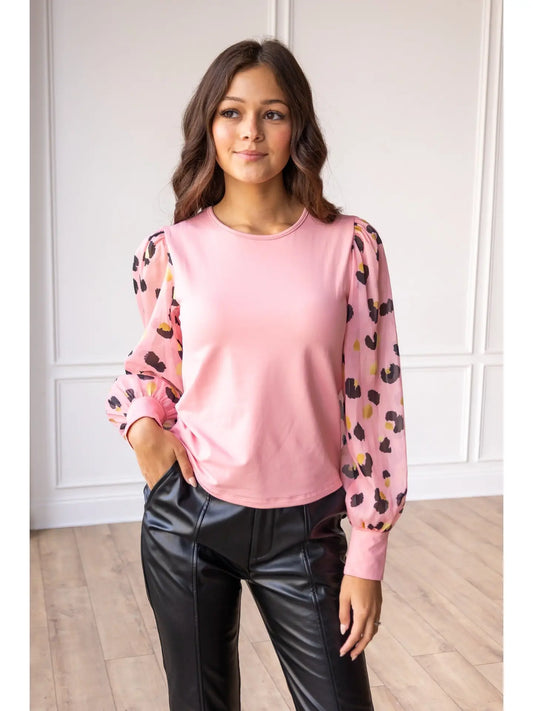Pink Leopard Sleeve Top is a stylish blend of simplicity and boldness. Featuring sheer leopard-print puff sleeves and a sleek solid bodice.