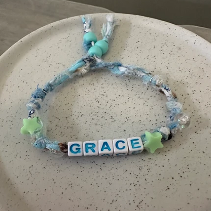 Grace Blue Fabric Word Bracelet on display
