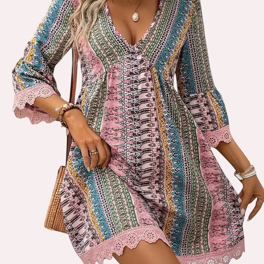 Trendy Merch Joelle Boho Lace Trim Mini Dress with V-neck, 3/4 bell sleeves, and colorful print. 100% Polyester.