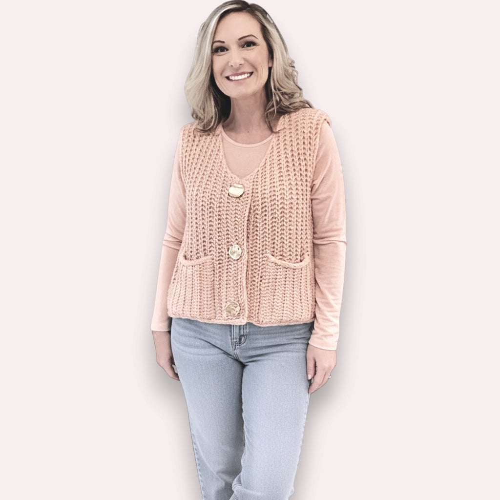 Trendy Merch peach knit vest with gold buttons and pockets, worn over a peach long-sleeve shirt and light wash jeans.